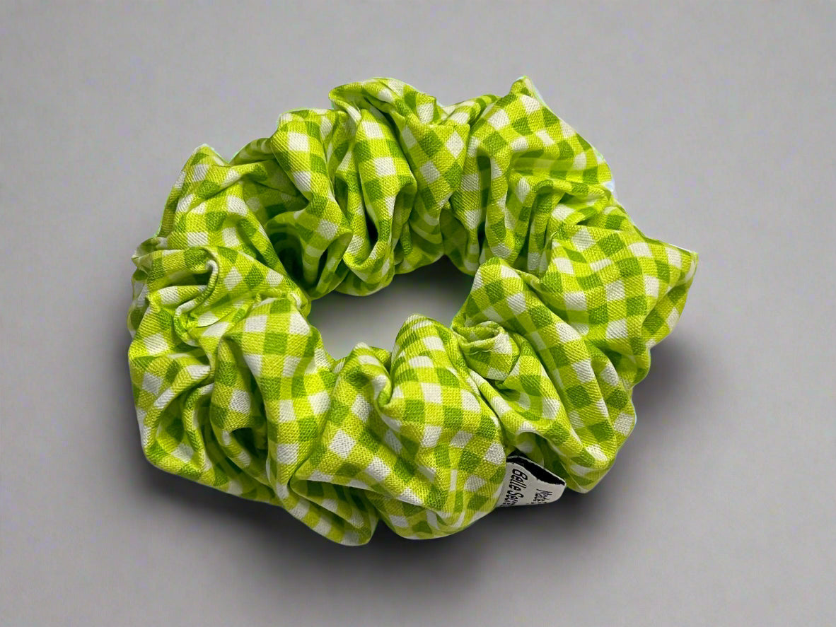 Green and white checkered scrunchie on a light gray background
