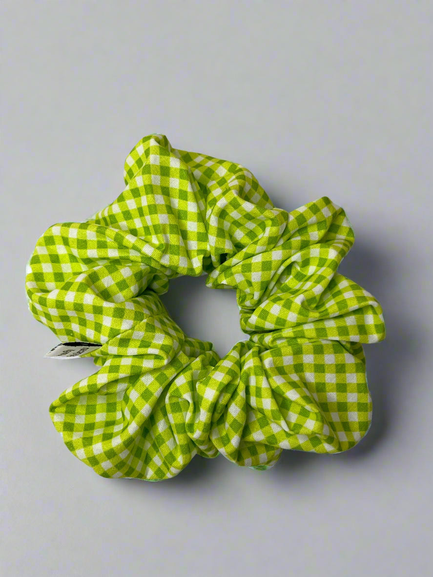 Green and white checkered scrunchie on a light gray background
