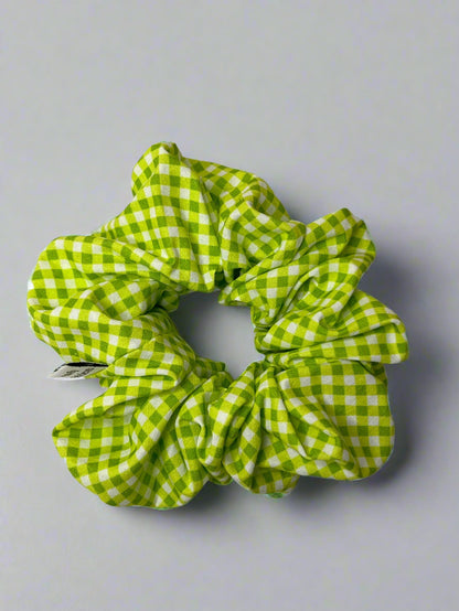 Green and white checkered scrunchie on a light gray background