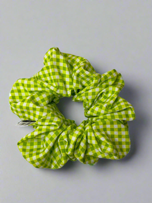 Green and white checkered scrunchie on a light gray background