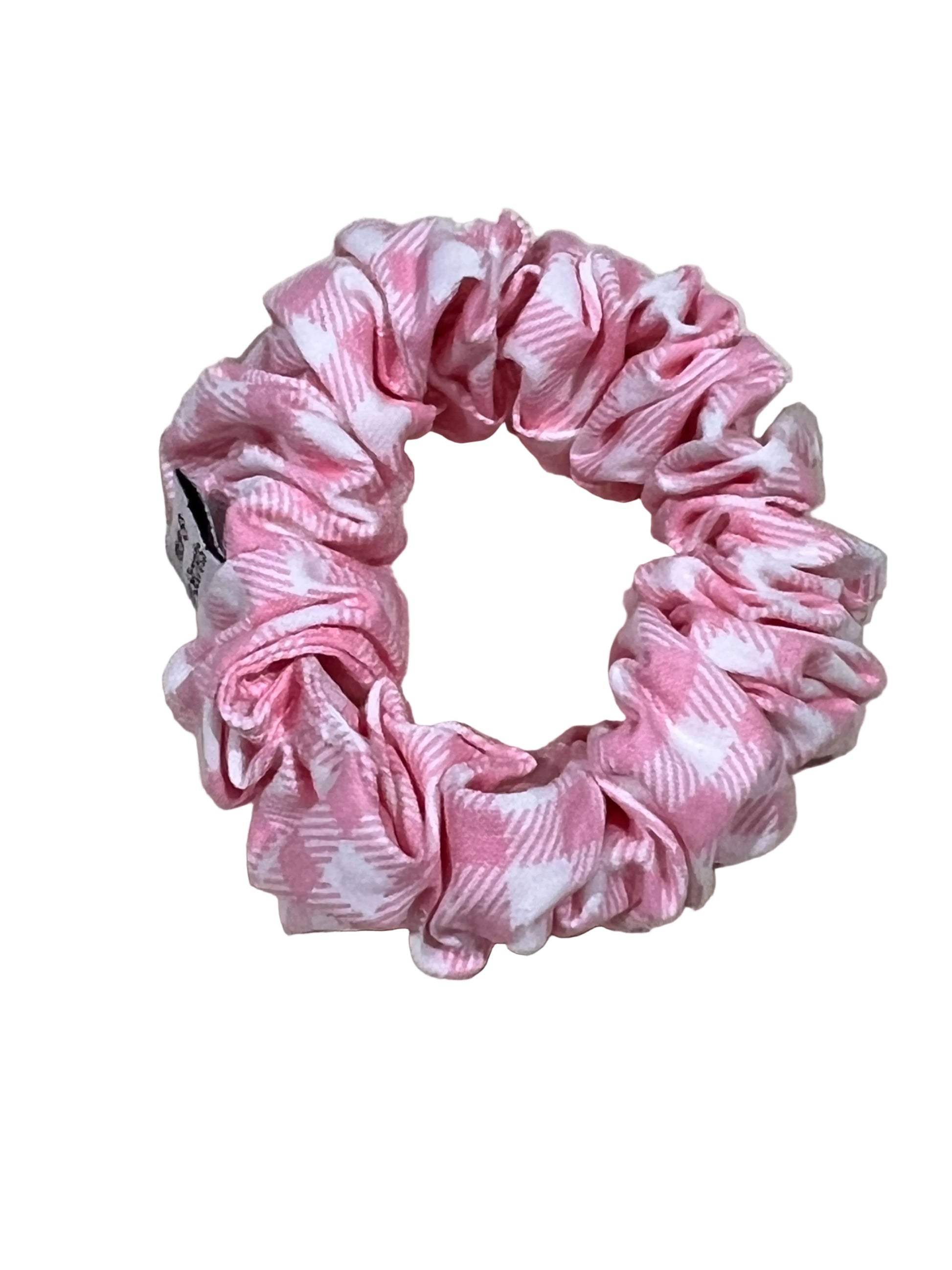 Pink and white patterned scrunchie on a beige background