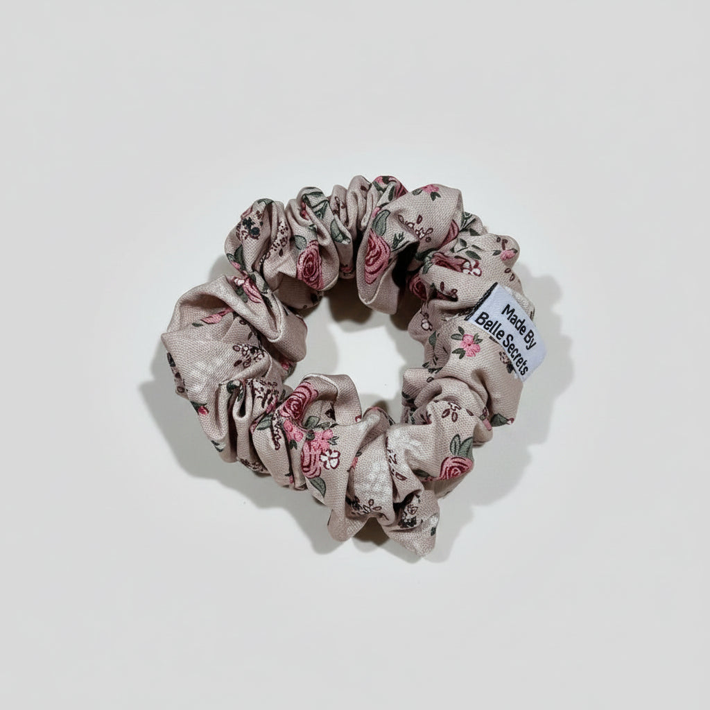 Floral scrunchie with a label on a beige fabric background